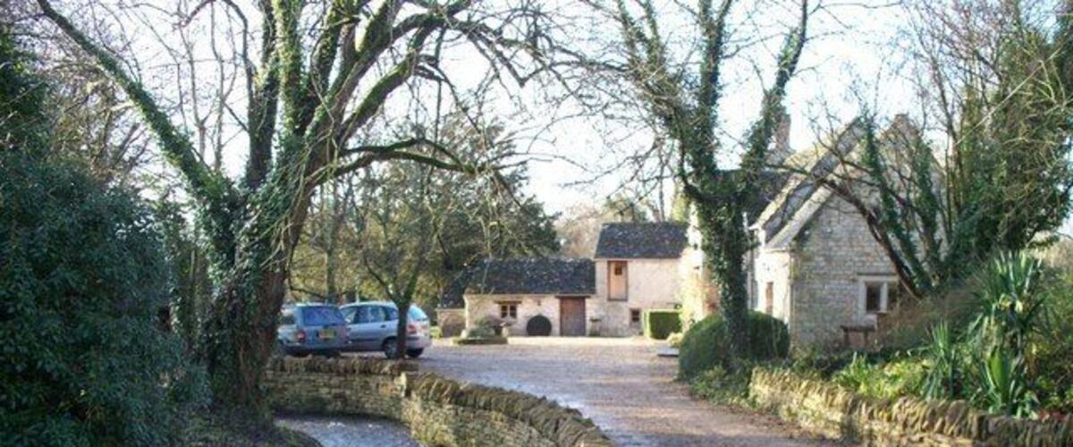 River Coln at Syreford The infant River Coln runs alongside the road in this attractive village. The river has just passed under a bridge which has taken it from one side of the road to the other.