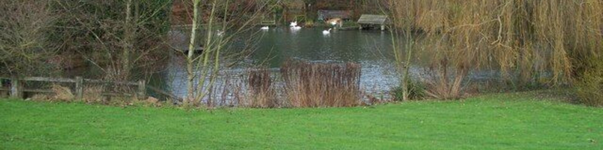 Lake at Shipton Solers This beautiful lake is part of a garden at the bottom of the valley in Shipton Solers. Seen from the footpath.