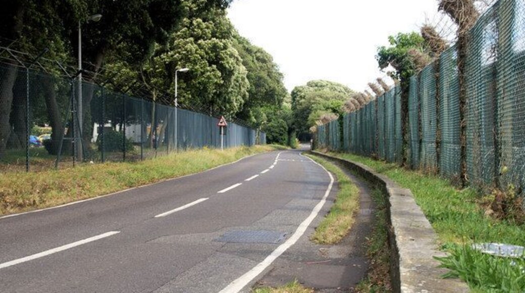 Fort Road Looking west from near Crescent Road. Both sides of the road here are lined with high fences and razor wire.