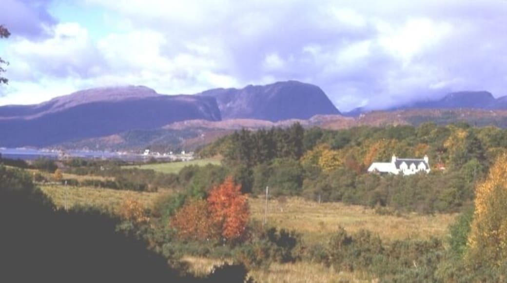 Fernaig. Beyond the autumn colours of the woods around Fernaig is the hamlet of Ardaneaskan on outer Loch Carron, with the mountains of Applecross in the distance.