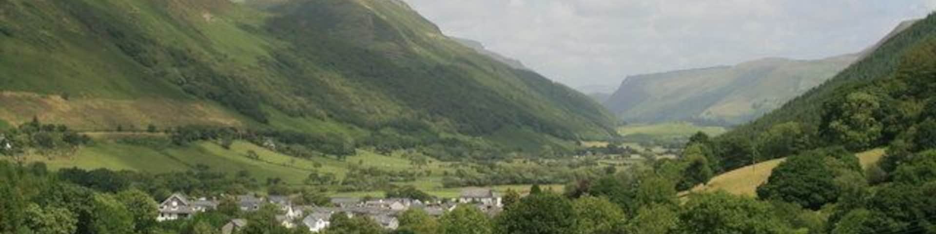 The village of Abergynolwyn, Gwynedd. Abergynolwyn and the valley beyond taken from the Talyllyn railway walk near Abergynolwyn station. On the left is the B4405 heading towards Dolgellau.