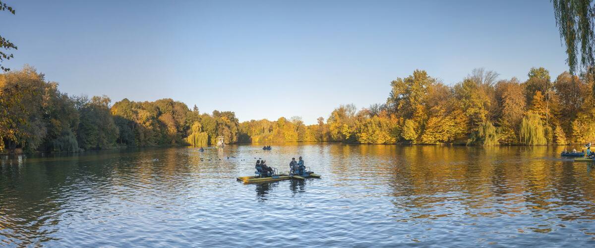 A calm lake surrounded by autumn trees.