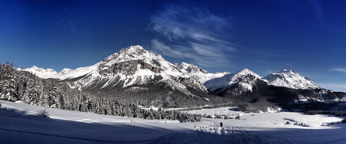 A snow-covered mountain range with a clear sky.