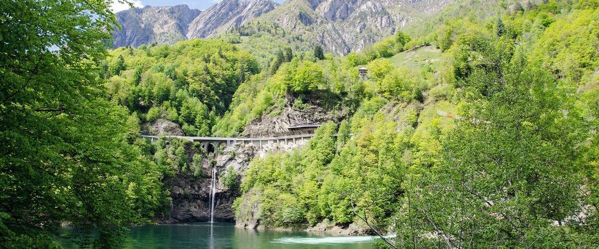 A river with a bridge and a waterfall.