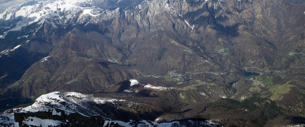 A mountainous landscape with snow-capped peaks and valleys.