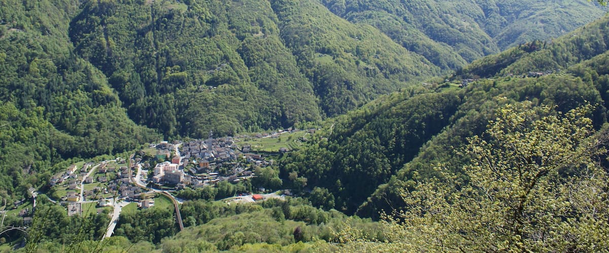 A mountainous landscape with a village nestled in a valley.