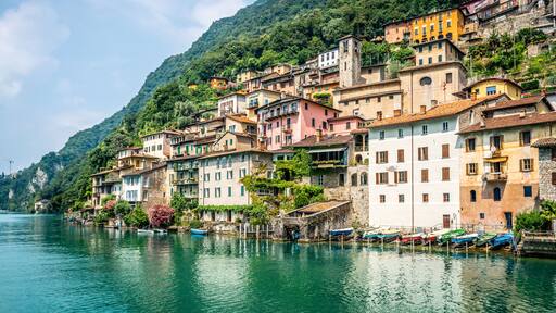 View of Gandria fishermen village with colorful houses on Lake Lugano lakeside on beautiful summer day in Switzerland