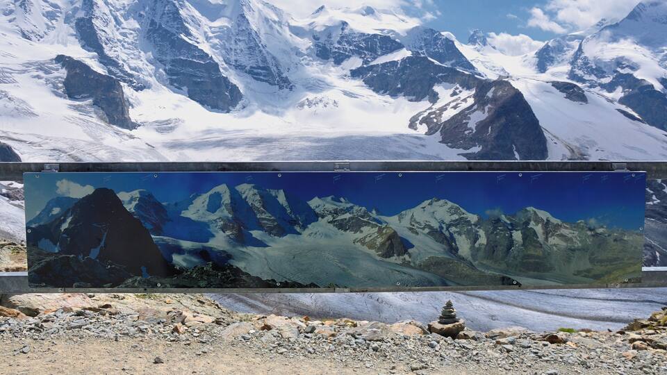 A snow-covered mountain range with a glacier in the foreground.