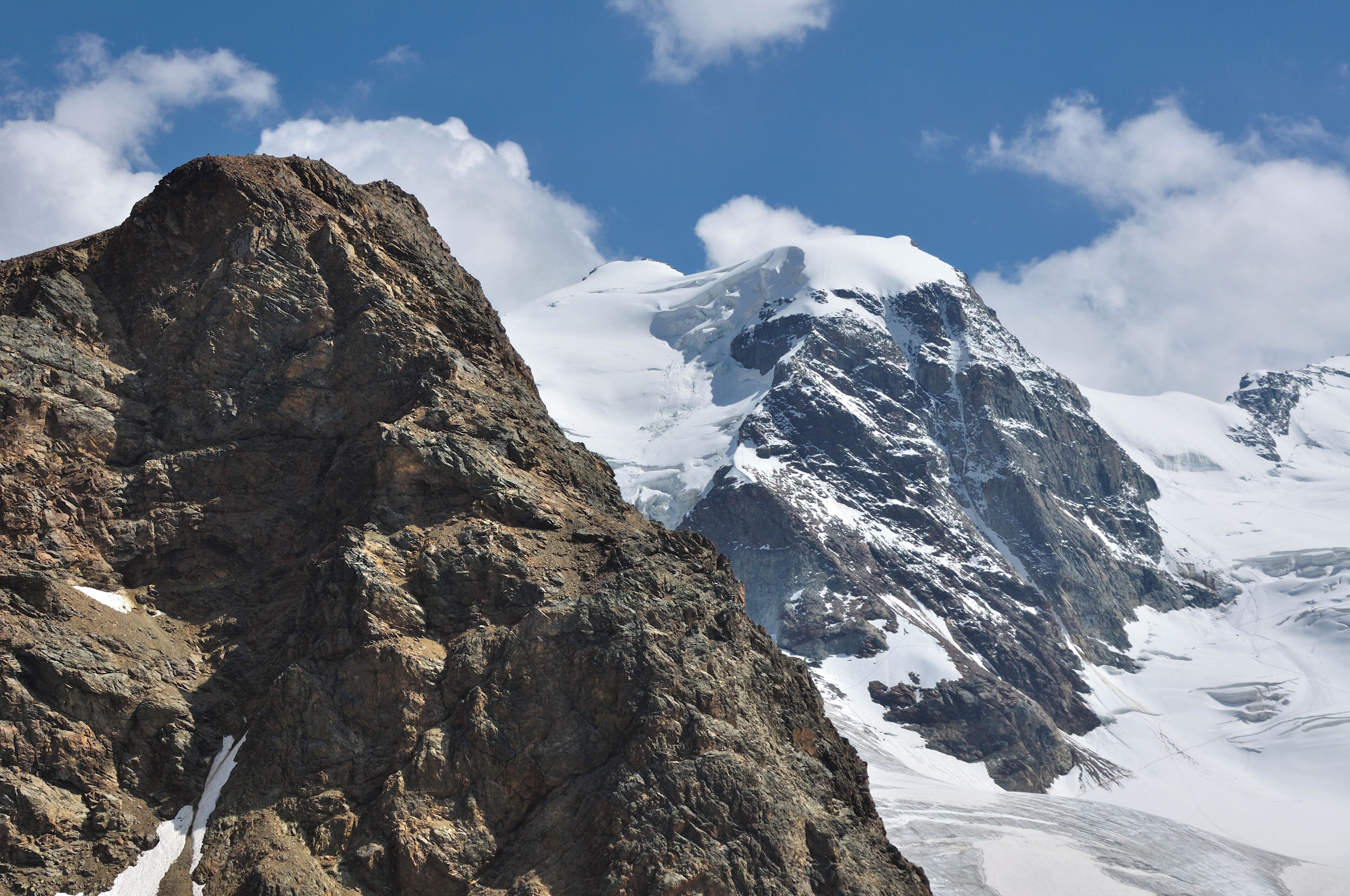 Rugged mountains with snow-covered peaks and rocky terrain.