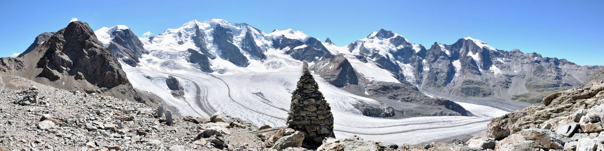 A snow-covered mountain range with a glacier.