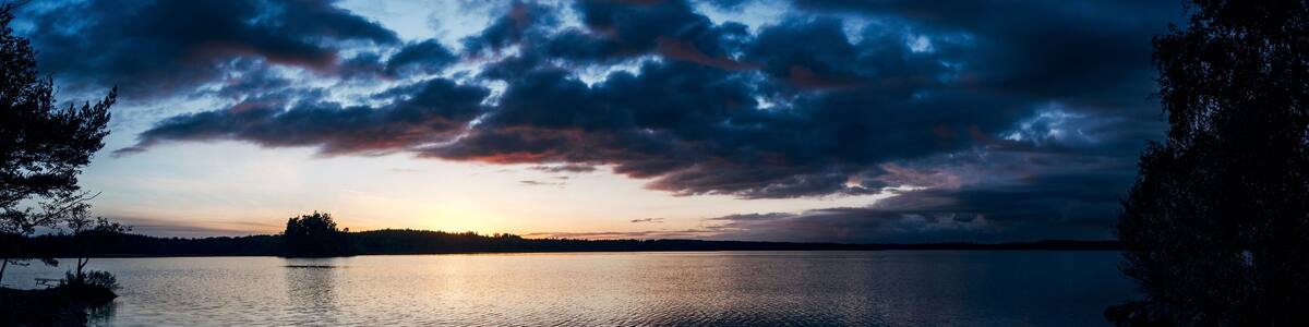 Dark sunset behind clouds over a seascape in Unnaryd, Sweden