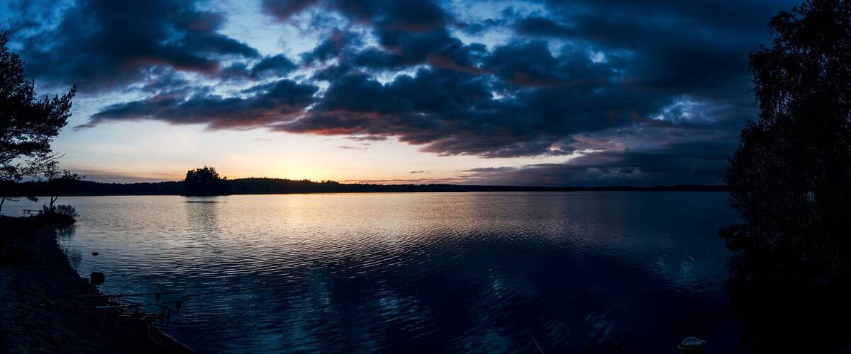Dark sunset behind clouds over a seascape in Unnaryd, Sweden