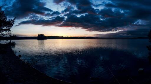 Dark sunset behind clouds over a seascape in Unnaryd, Sweden