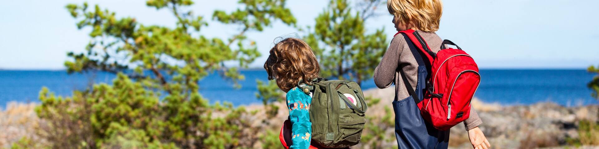 Brother and sister walking at sea