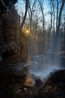 Standing behind the waterfall "Bratteforsfallet" on the mountain Kinnekulle in Sweden