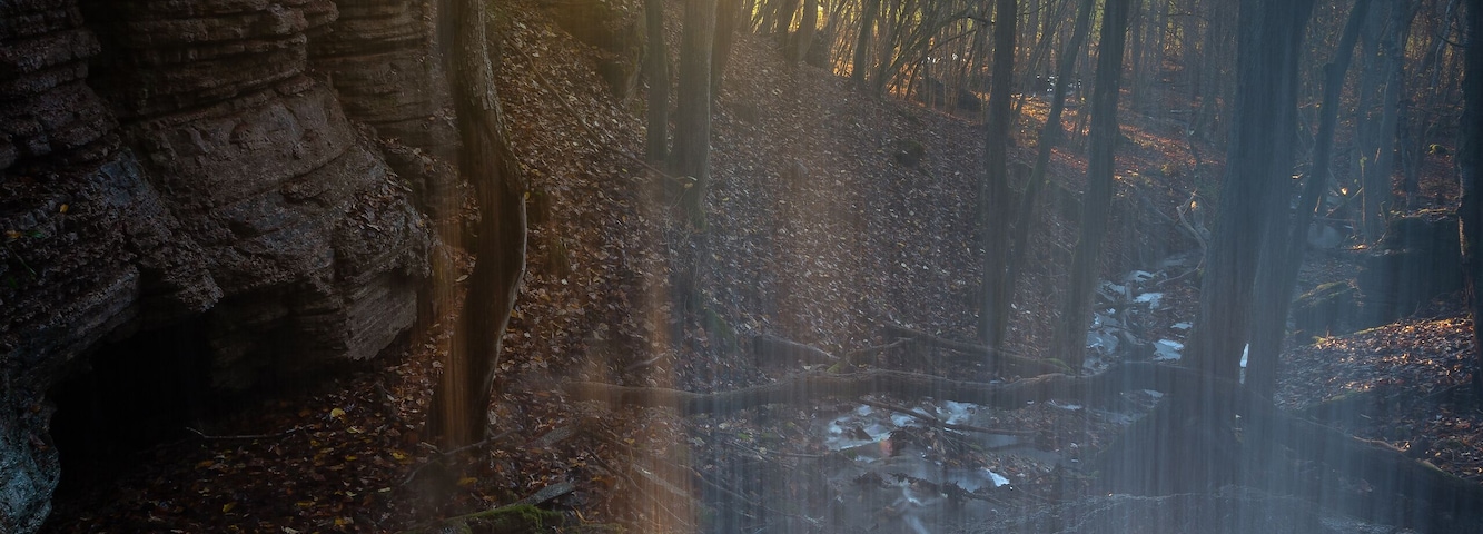 Standing behind the waterfall "Bratteforsfallet" on the mountain Kinnekulle in Sweden