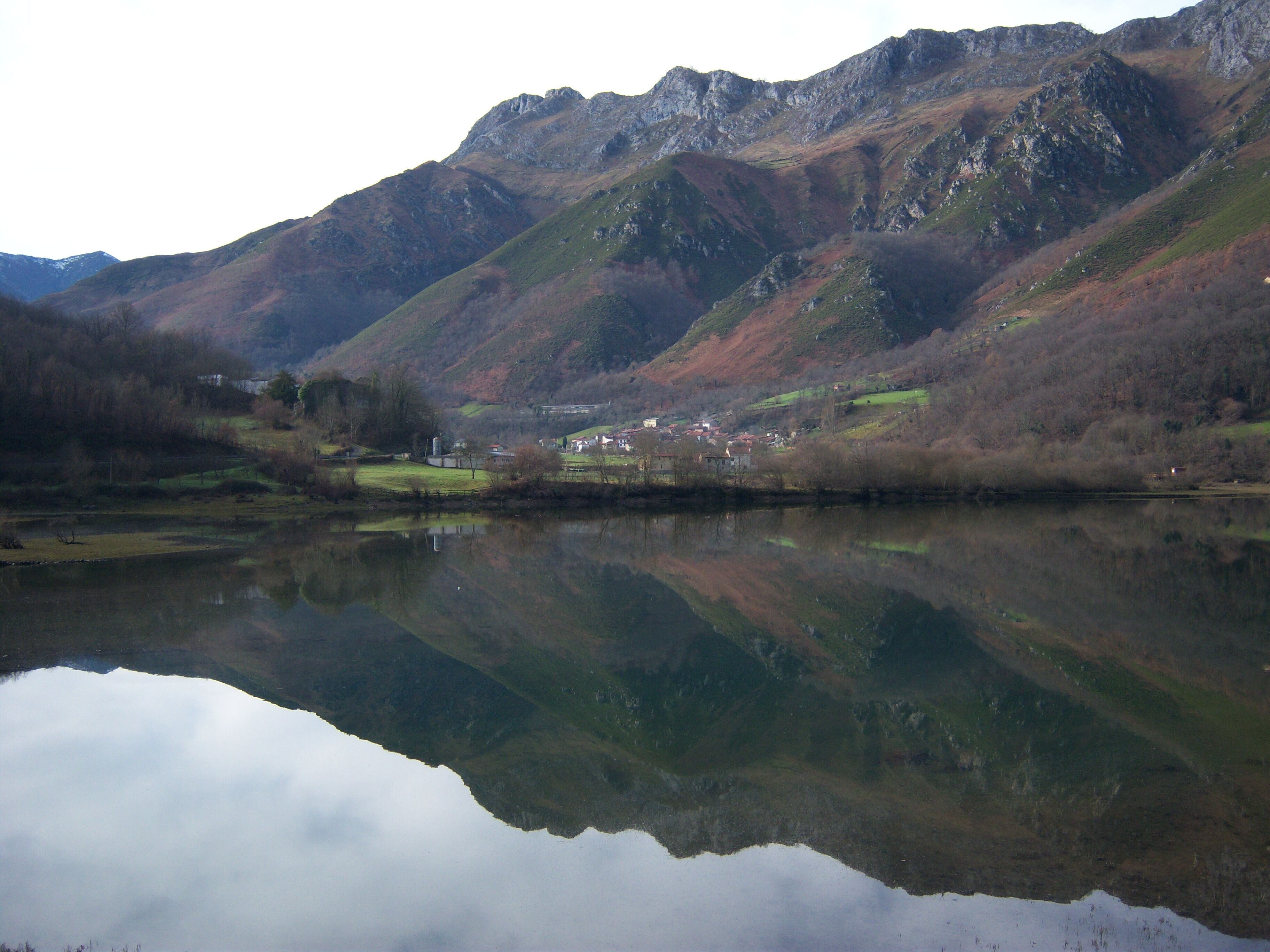 A mountainous landscape with a lake reflecting the scenery.