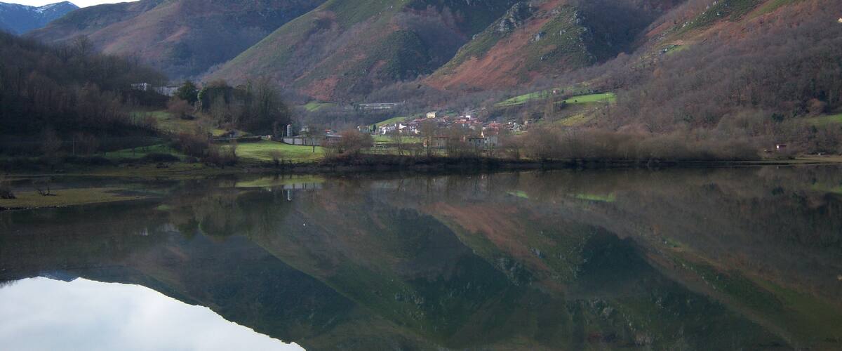 A mountainous landscape with a lake reflecting the scenery.