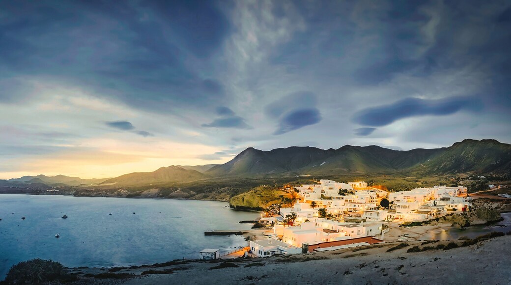 relaxing panoramic view of the sunset over the sea and the quiet village of la isleta del moro in the natural park of cat cape