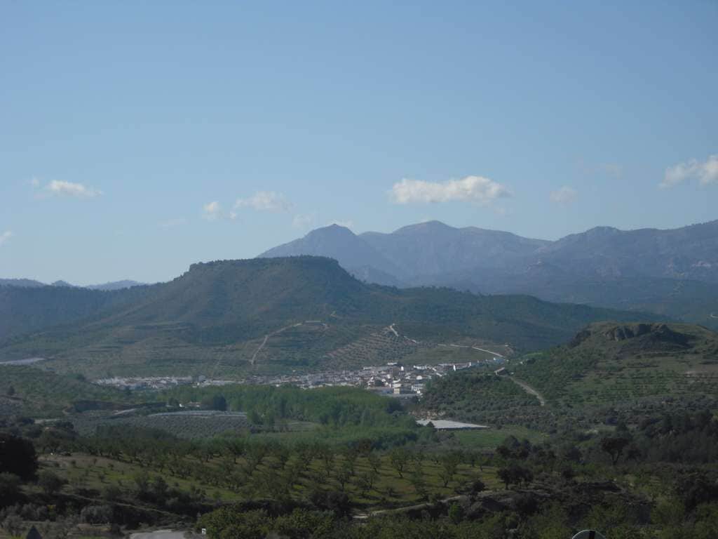 A mountainous landscape with a town nestled in the valley.