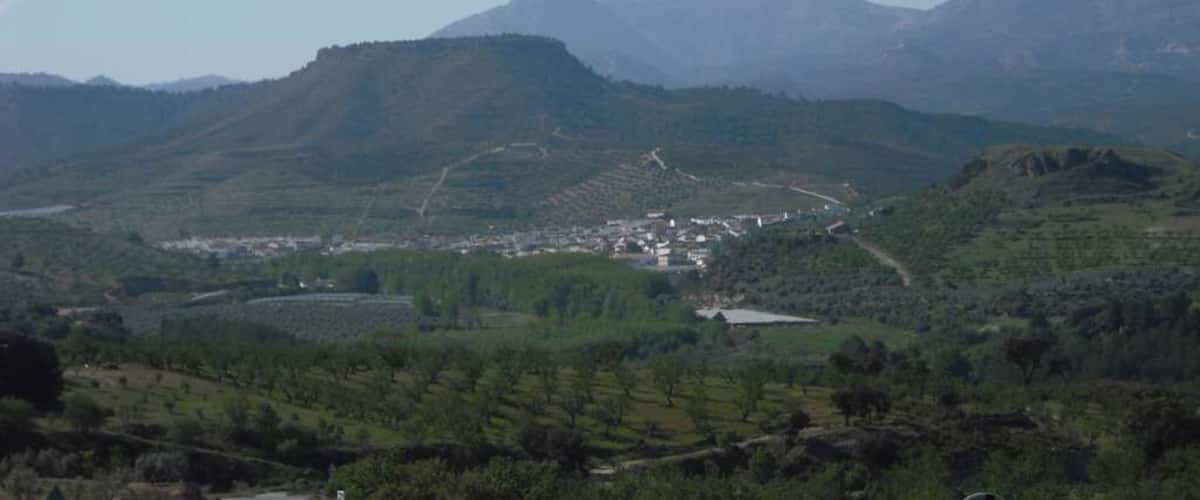A mountainous landscape with a town nestled in the valley.