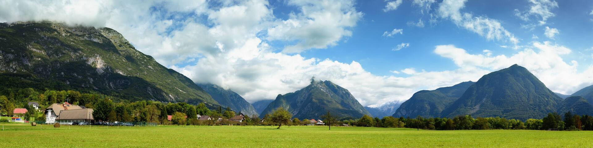 Beautiful panoramic landscape of Julian Alps near Bovec, Slovenia. Scenic nature of green valley surrounded by high mountains