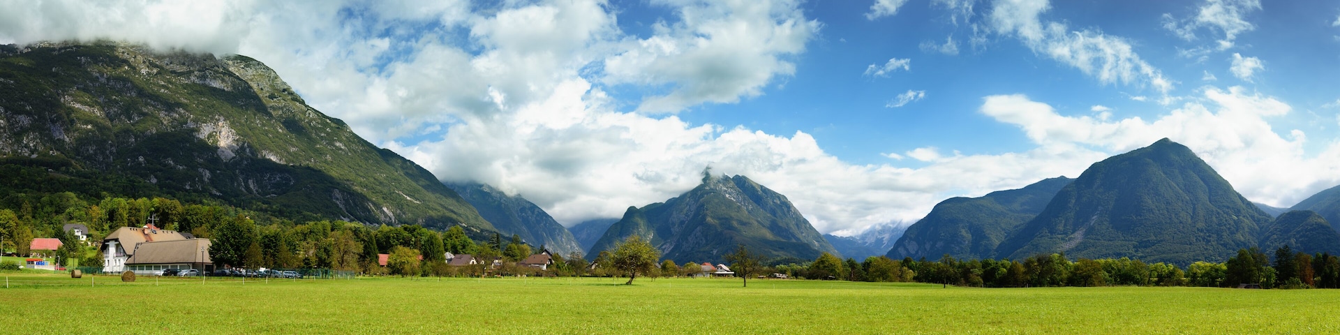 Beautiful panoramic landscape of Julian Alps near Bovec, Slovenia. Scenic nature of green valley surrounded by high mountains