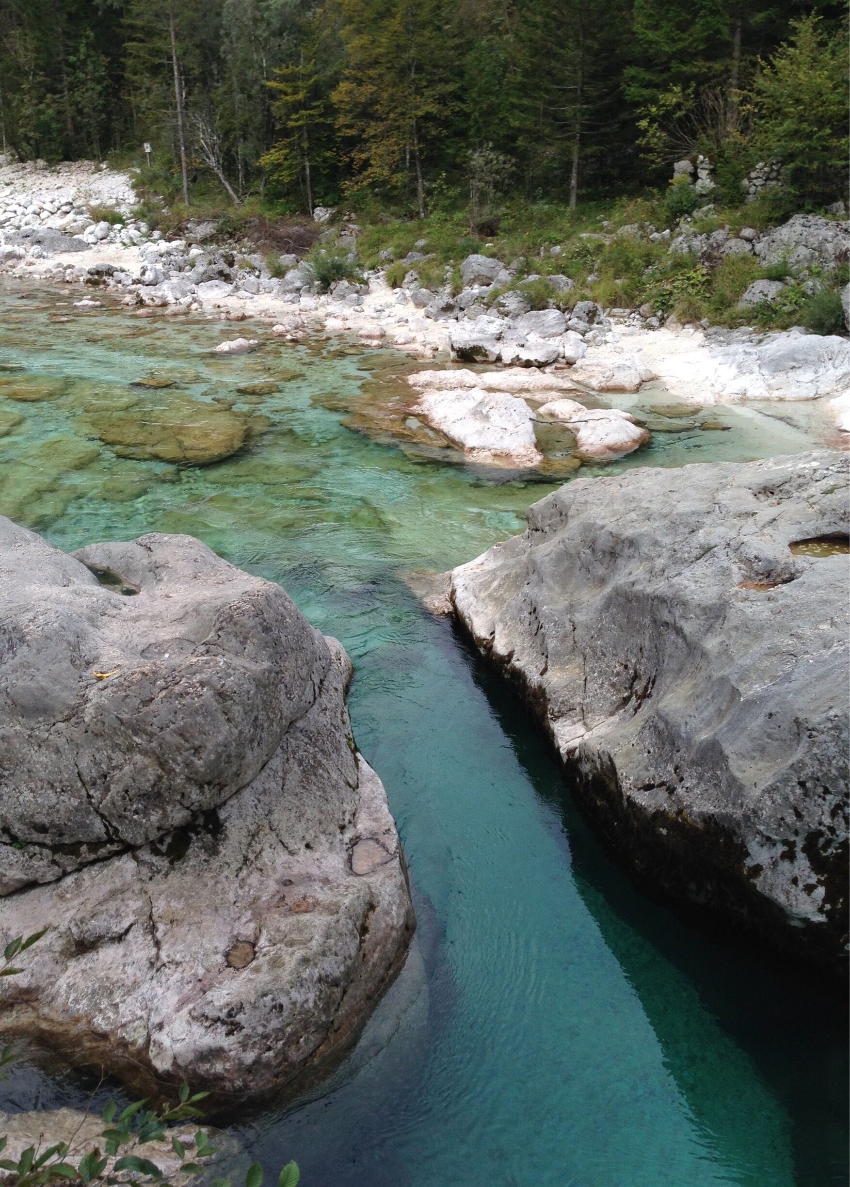 The Soca River in Slovenia is a popular destination for kayakers and fly fishermen. It is one of the few rivers where a Marble Trout can be caught. The water is a vibrant turquoise as seen in this non-retouched photo. #Colorful