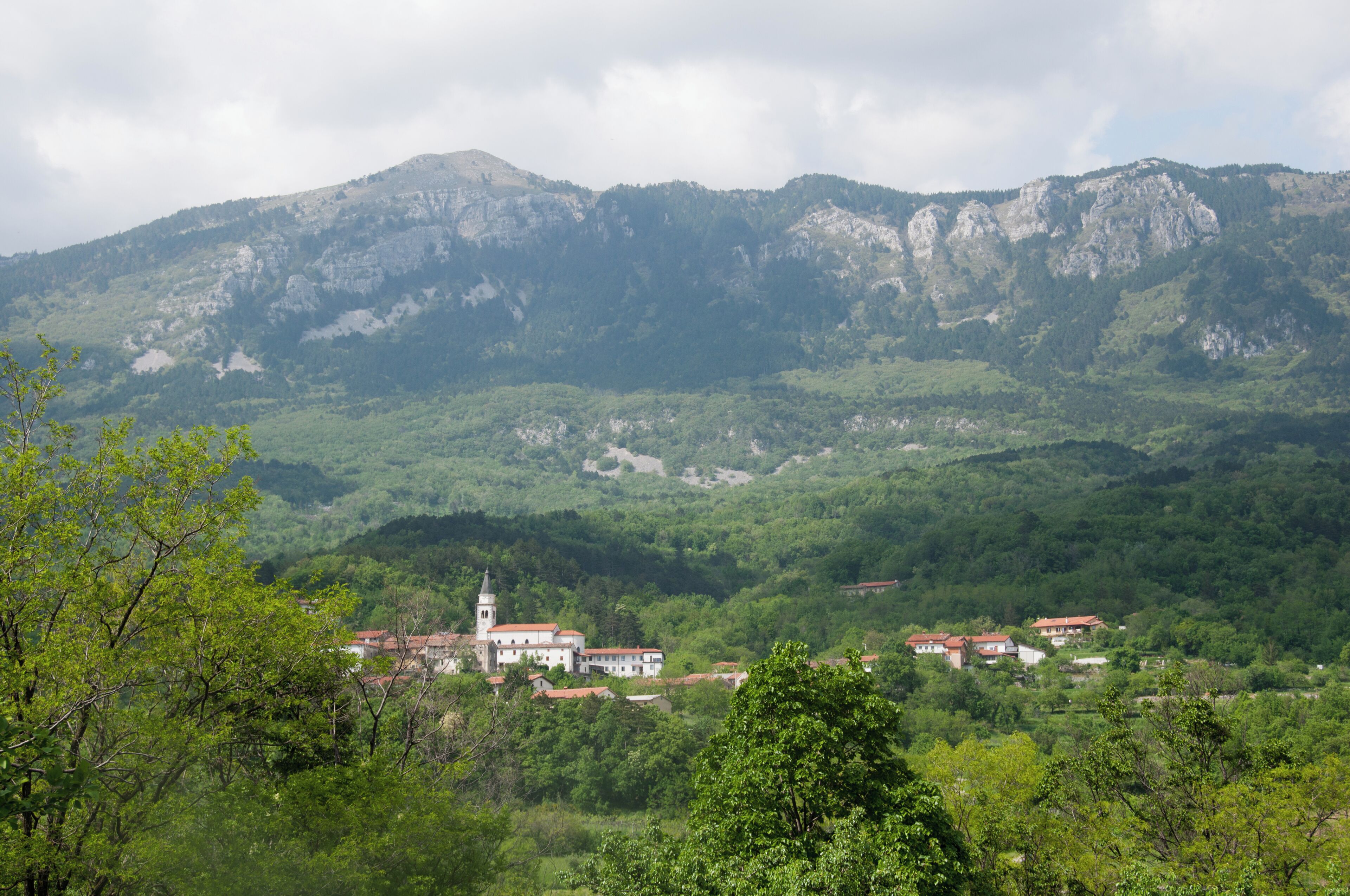 A mountainous landscape with a village nestled in the valley.