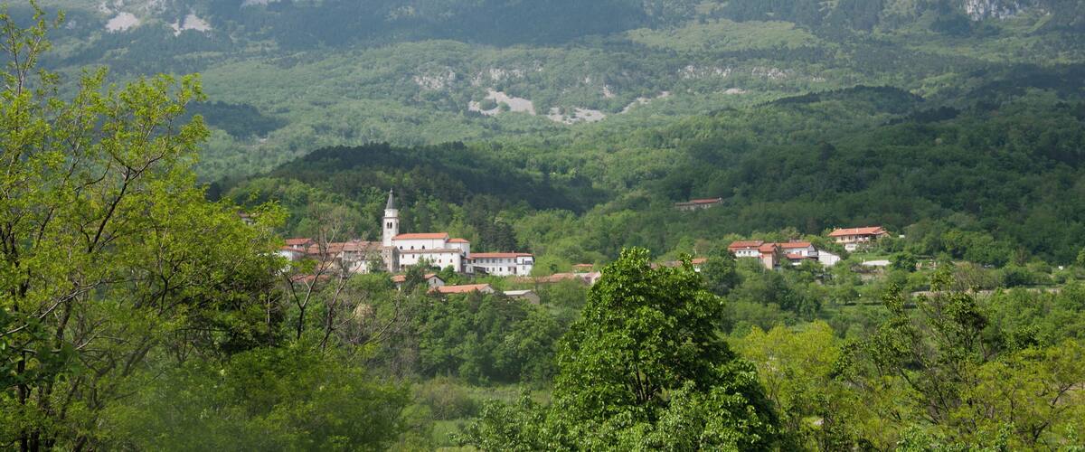 A mountainous landscape with a village nestled in the valley.