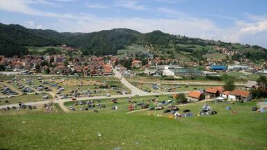 View of Guča from a hill.
This small Serbian village hosts a joyful trumpet festival at the beginning of August. Brass bands are playing day and night throughout the city. Although there were many people, there was a lot of space to move freely and dance cheerfully.
Guča can be reached by bus from čačak (1h, 200dinars, 1 bus per hour during the festival). There are many possibilities to camp around the city (Brass Town is the official campsite) and there is also a public swimming pool.
#festival