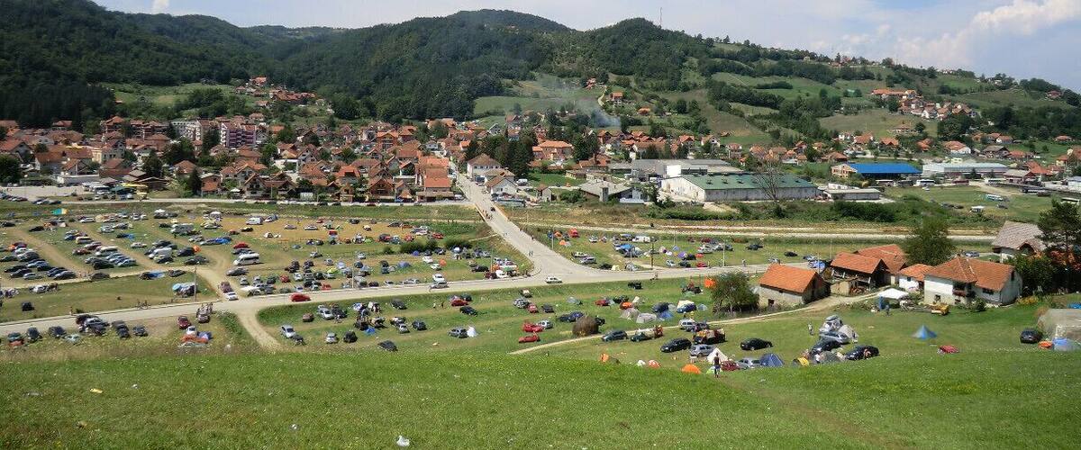 A town with a central road leading to a hilltop.