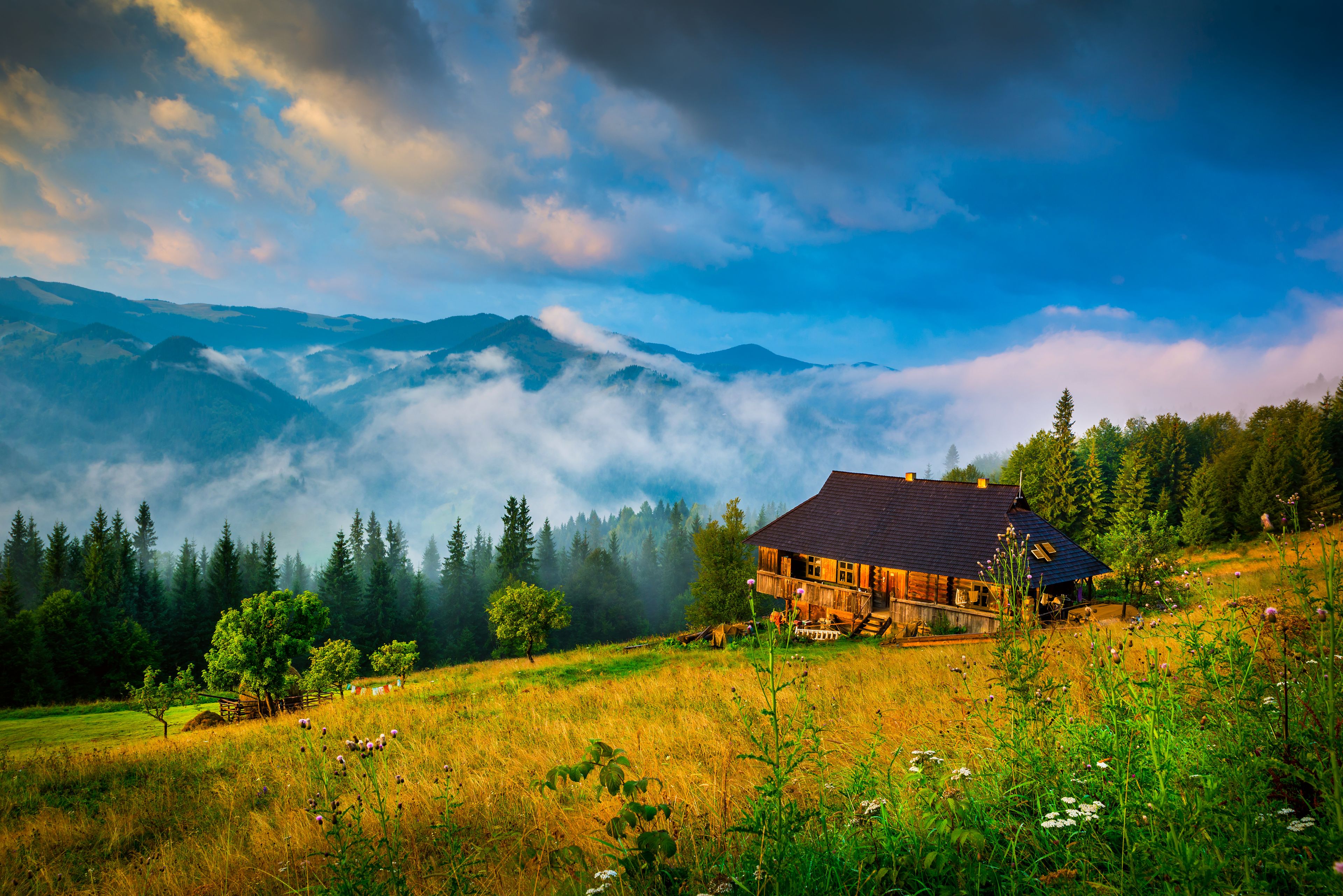 Amazing mountain landscape with fog and a haystack