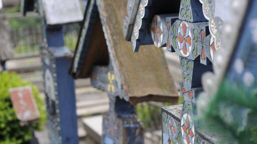 'This stillness is a big part of the MaramureĆ lifestyle; being able to experience it actually means understanding a way of life that has been passed on from one generation to the next and these peopleâs take on life is as surprising as their take on death.
The best place for us to experience that was SÄpĂąnĆŁa, a small yet cozy village close to the Ukrainian border. What makes the inhabitants of MaramureĆ so special, in the end? Well, for starters, they even have a cemetery making a fool of⊠death. Yes, death. Stepping into the Merry Cemetery made it clear. This cemetery has mainly started as the creation of sculptor Stan Ioan PÄtraĆ, whose legacy endured after his death, with artists who continued his beautiful work, using the same vibrant blue â the SÄpĂąnĆŁa blue, together with other vivid colors to illustrate the resilience of the miracle of life before the big end. There are important scenes from the lives of those buried here painted on over 800 tombstones. And if this isnât impressive enough, there are epitaphs underneath each painting summarizing the life of the deceased or depicting the circumstances of the passing, with traditional Romanian motifs found in each epitaph.'
#blue #colorful
