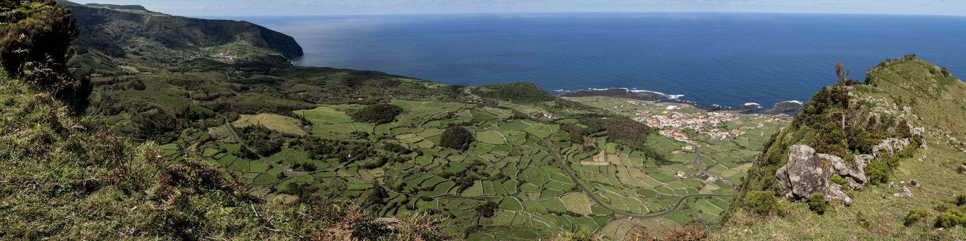 Panorama over a cliff, part of the PR3 trail, with excellent views of the west coast with the parishes of Fajã Grande and Fajãzinha below. Flores Island, Portugal.
