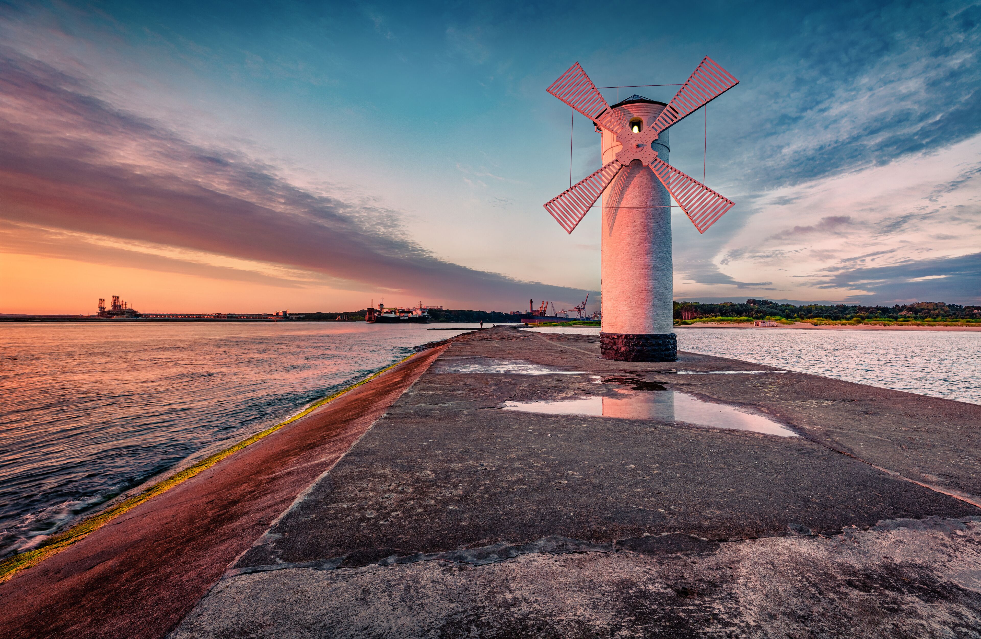 Astonishing summer view of Stawa windmill. Breathtaking sunrise on Szczecin Lagoon. Nice morning seascape of Baltic Sea, Swinoujscie, Western Pomerania, Poland, Europe. Traveling concept background..