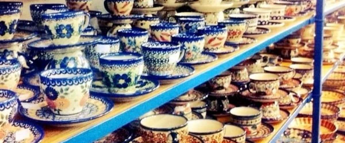 Shelves stocked with various ceramic bowls and plates.