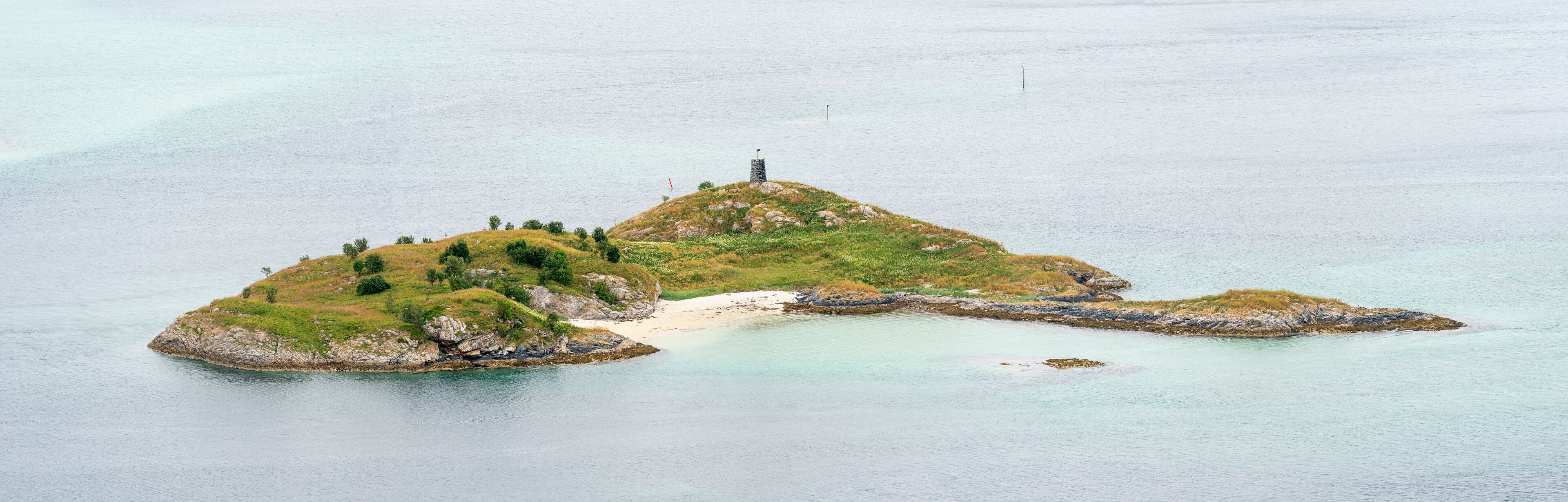Panoramic view of a small island surrounded with turquoise sea water. Sommarøy, Troms County, Northern Norway