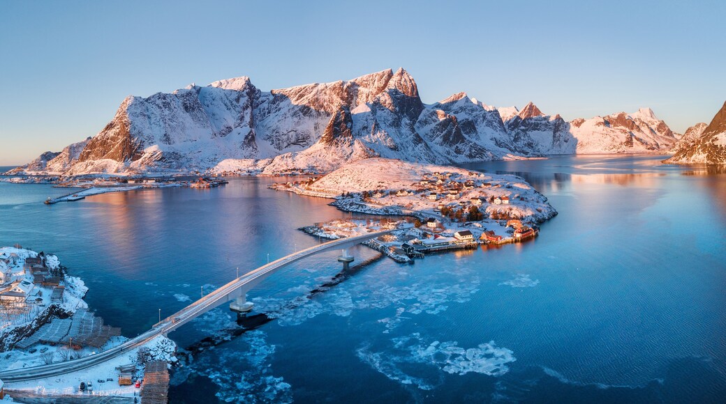 Aerial view at the Lofoten islands, Norway. Mountains and sea during sunset. Natural landscape from air at the drone. Norway at the winter time