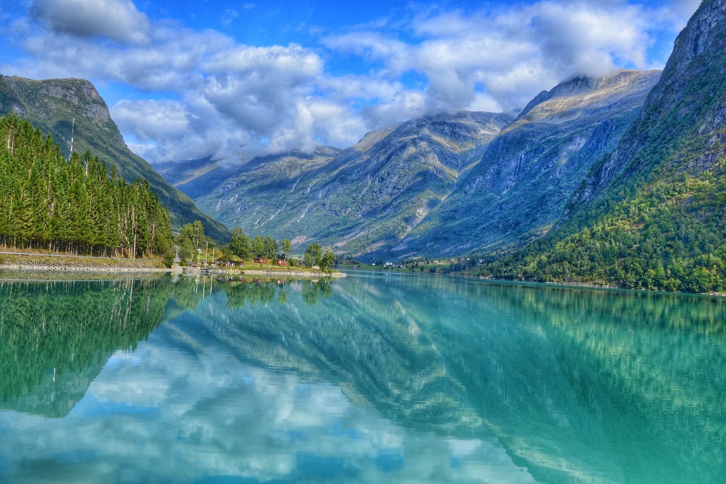 A mountain lake with clear turquoise water reflecting the surrounding landscape.