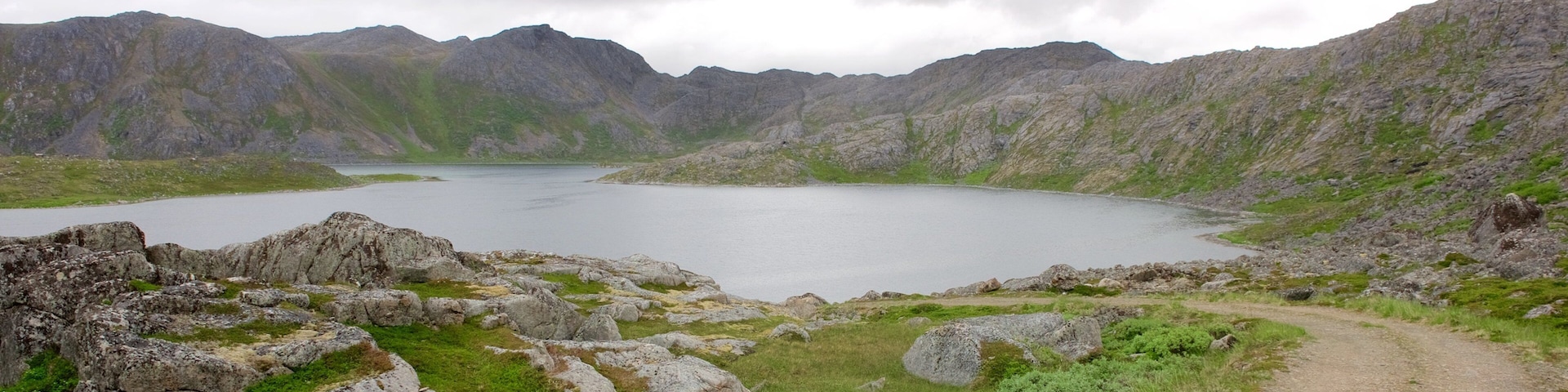 Nordkapp which includes mountains and a lake or waterhole