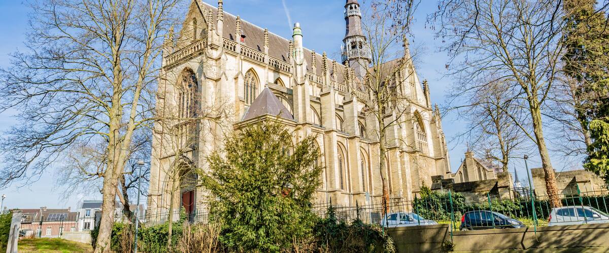 A historic church with a tall spire and intricate architecture.