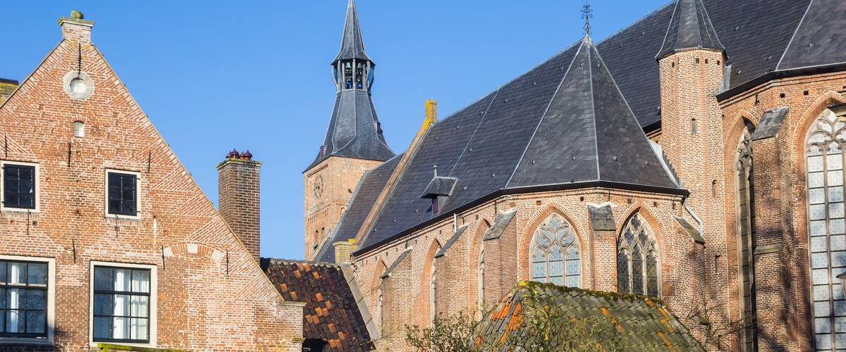 A historic church with multiple spires and a clock tower.