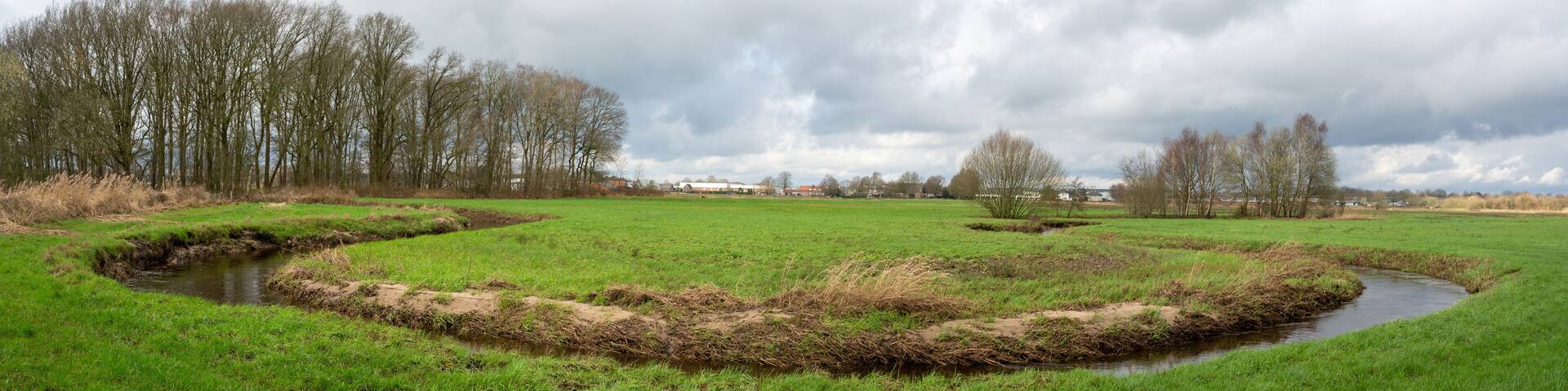 Rovertse Leij river winding through meadows outside of Goirle in The Netherlands