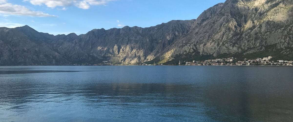 A mountainous landscape with a lake and a small town.
