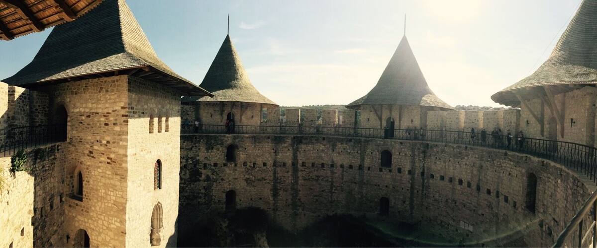 A medieval castle with three prominent towers and a central keep.