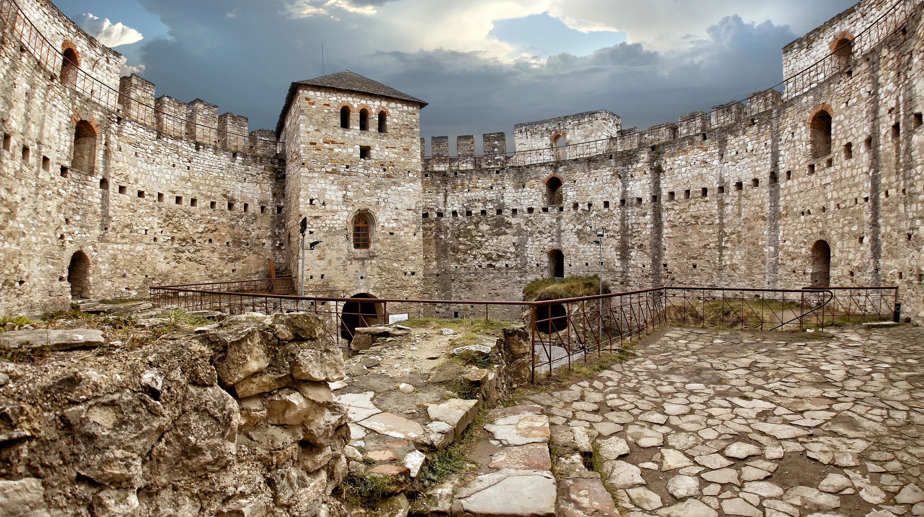 A historic stone fortress with multiple arched windows and a central tower.