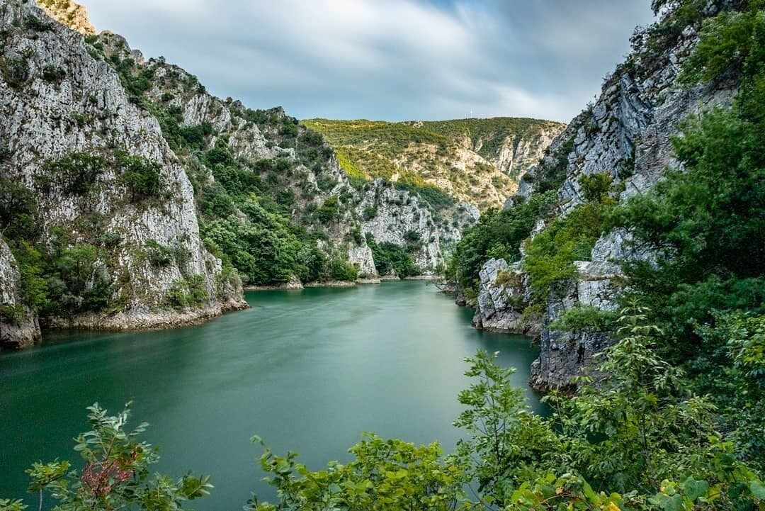 Matka Canyon is amazing green valley near Skopje, with a long artificial dam on Treska River, and very popular spot between tourists and also locals - Macedonians. Surrounding mountain are great for trekking and climbing, the lake attracts to make a boat or kayak trip and explore ancient monasteries and caves. But you can enjoy it also by walking along the canyon, on the carved pathway. Canyon is connected with Skopje by  no. 60, so count with many visitors during the season. We can recommend around 10 km long trek over the mountains from the Millenium Cross.

#zcesty
#amazingplaces
#macedonia
#northmacedonia
#matka
#landscape
#nature
#canyon
#europe
#travelling