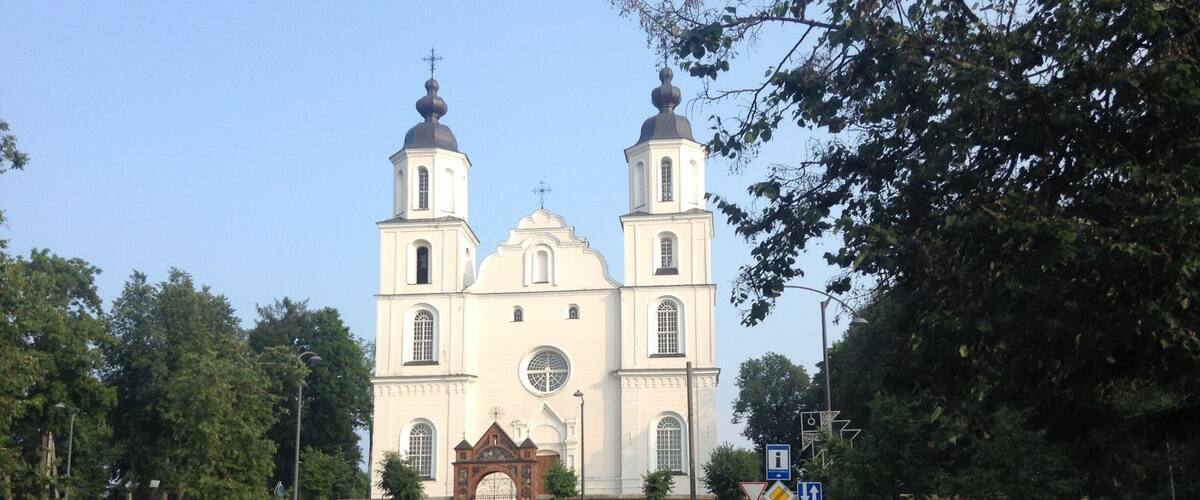 A large white church with two towers and a central dome.