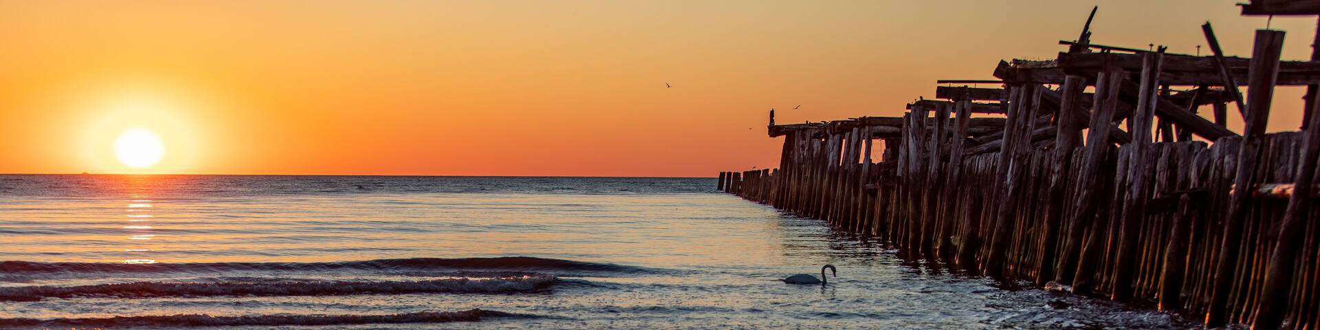 Sunset and old bridge ruins in Sventoji Lithuania